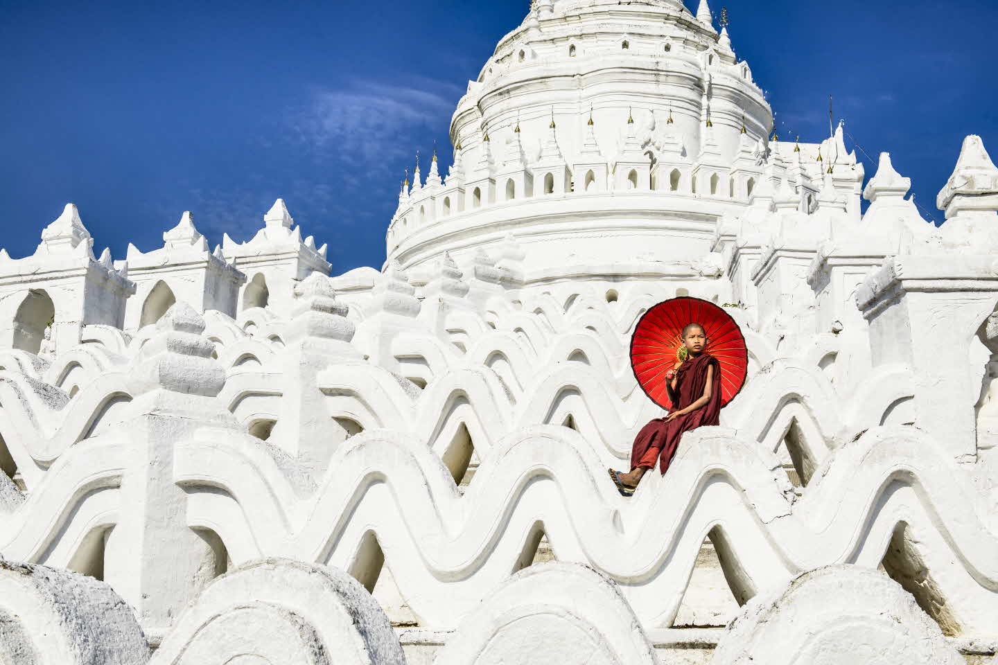 Asian woman sitting on temple walls, Mingun, Saigang, Myanmar